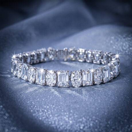 A luxurious sterling silver tennis bracelet featuring alternating emerald-cut and oval-cut moissanite stones