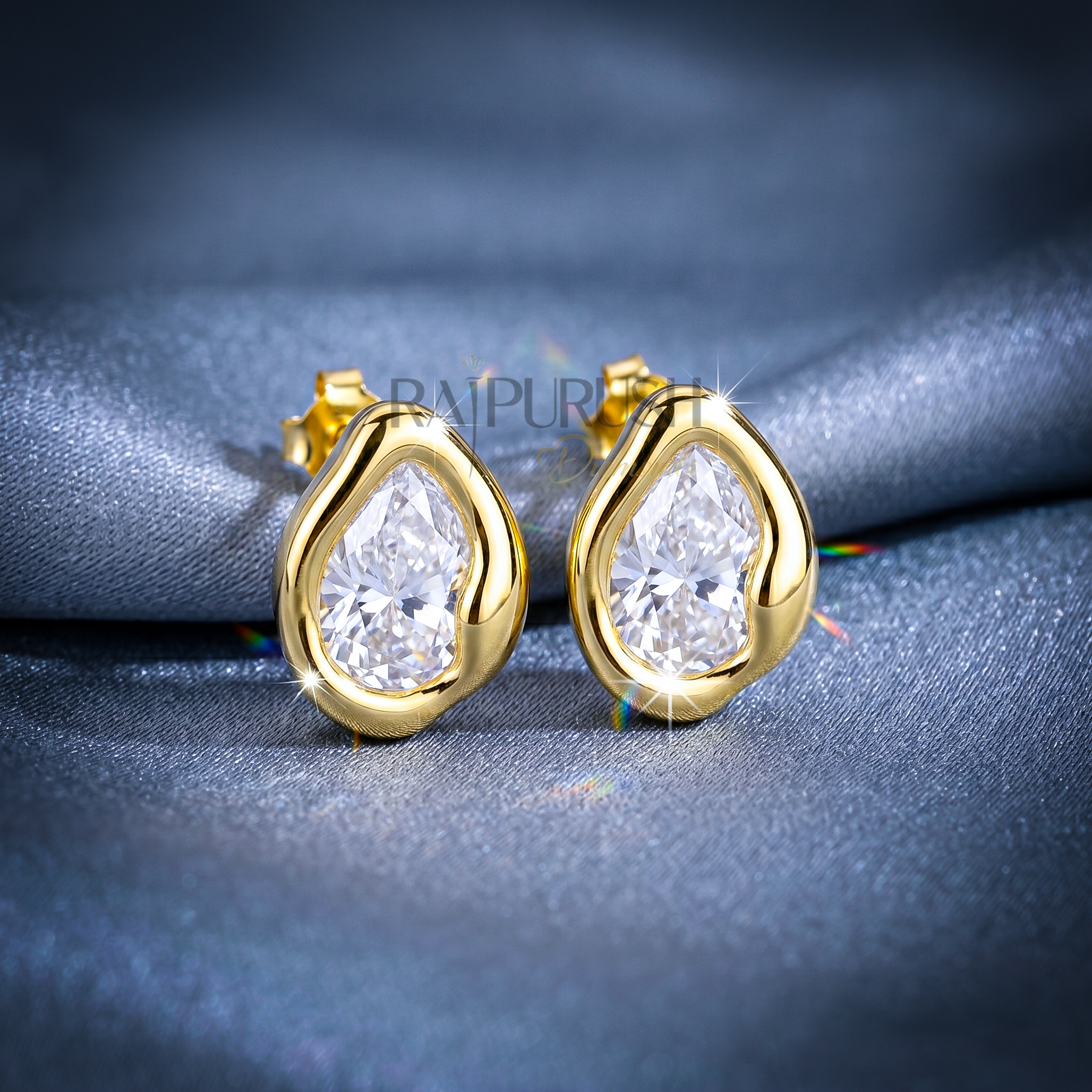 A pair of 2ct each pear-cut moissanite stud earrings in a secure bezel setting, crafted in S925 with polished 14k gold