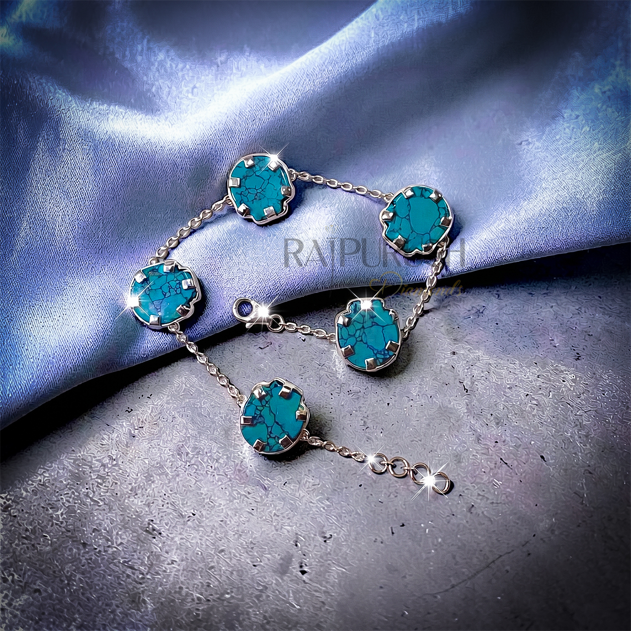 Unisex 925 sterling silver hip hop station bracelet featuring five skull-shaped turquoise stones framed with milgrain borders.Full length view of an edgy streetwear turquoise skull link chain bracelet laid out on a shimmering blue satin surface.