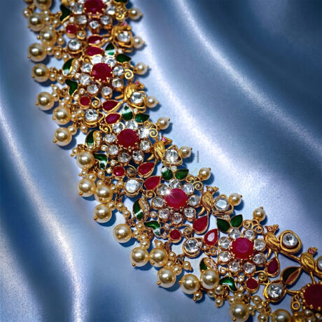 Traditional Indian heritage jewelry set featuring bird motifs with vibrant rubies and uncut Polki(uncut diamond)diamonds set in 18k yellow gold.