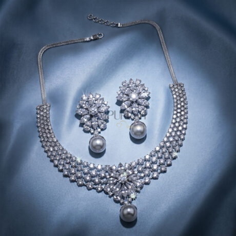 Stunning V-shaped cascading fringe moissanite statement necklace in premium 925 sterling silver showcased beautifully on a blue silk background.
