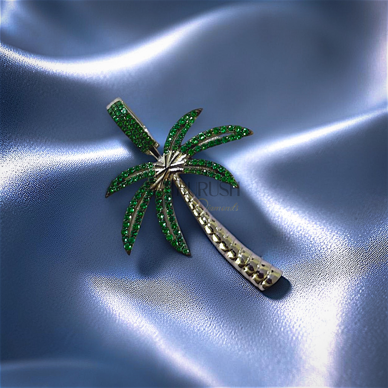 hip hop palm tree pendant fully iced out with white moissanite on the trunk and vibrant green moissanite stones on the leaves in 925 sterling silver.