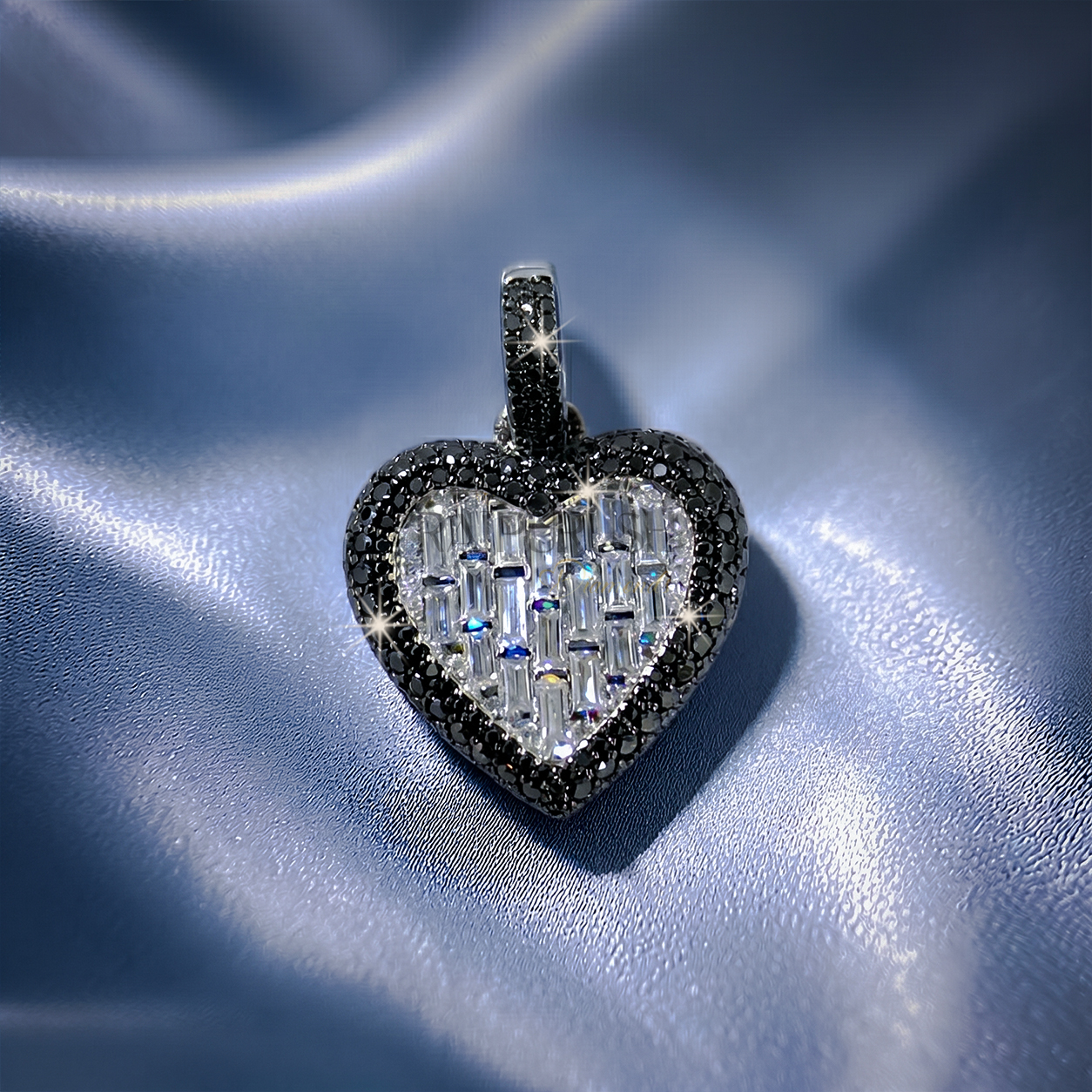 Bold iced-out heart pendant in 925 sterling silver featuring a center of seamless mosaic baguette diamonds bordered by a frame of black round moissanite stones.