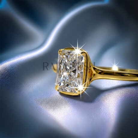 1 carat radiant cut solitaire engagement ring in 14k yellow gold plated sterling silver on a silk background.Side profile of a 1ct elongated radiant cut diamond simulant wedding ring with a modern cathedral bezel setting.
