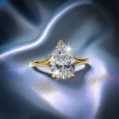 1 carat pear cut solitaire engagement ring in 14k yellow gold plated sterling silver, Side profile of a 1ct teardrop diamond simulant wedding ring showcasing a split shank cathedral setting. Under-gallery view of a gold plated pear cut solitaire ring showing the elegant open basket framework.