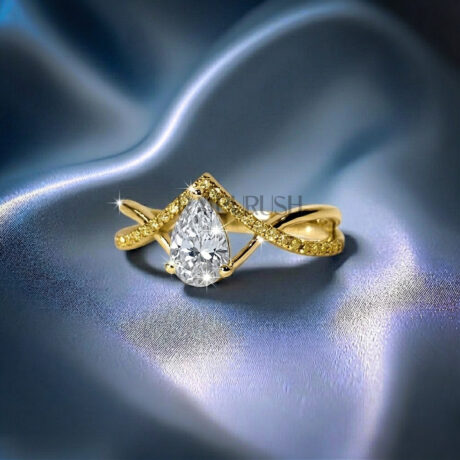 Elegant pear-cut moissanite engagement ring with a gold-plated criss-cross split shank band.