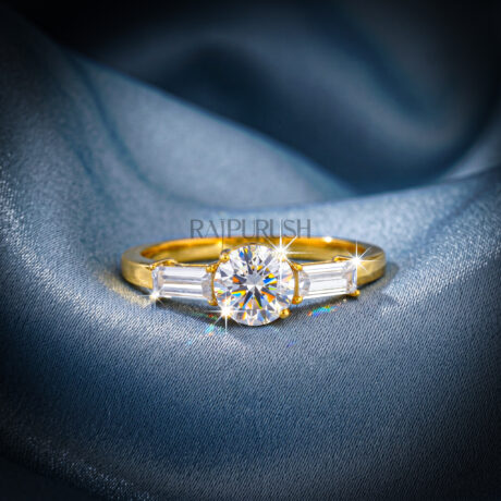 Elegant three-stone engagement ring featuring a round brilliant moissanite center with baguette side stones in 14k gold-plated silver.