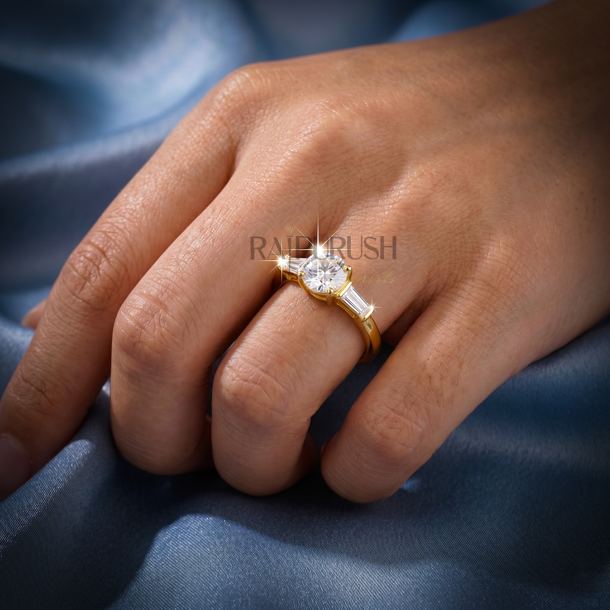 Elegant three-stone engagement ring featuring a round brilliant moissanite center with baguette side stones in 14k gold-plated silver.