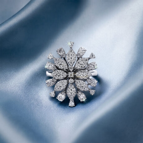 Brilliant cut moissanite snowflake statement cluster cocktail ring in 925 sterling silver beautifully centered on a shimmering blue silk background.
