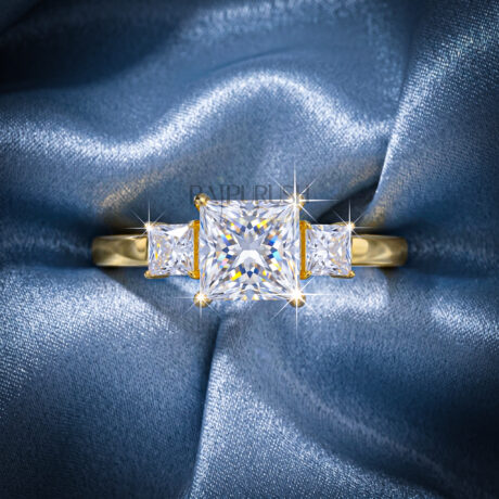 1.50 Carat princess cut moissanite engagement ring with two side stones in a classic three-stone setting, finished in 14k yellow/rose gold plating.