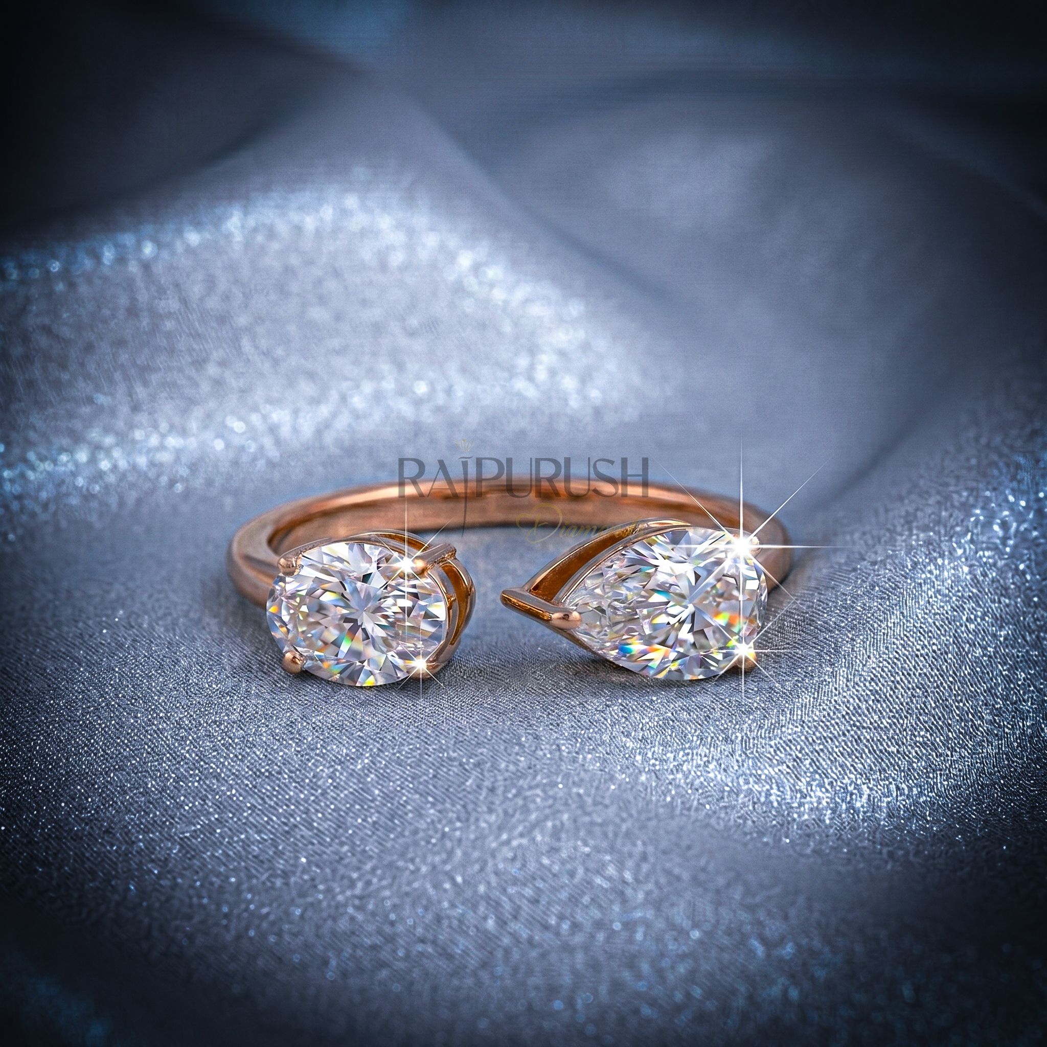 A modern "Toi et Moi" style engagement ring featuring pear and oval cut moissanite stones, finished in 14k yellow/rose gold plating.