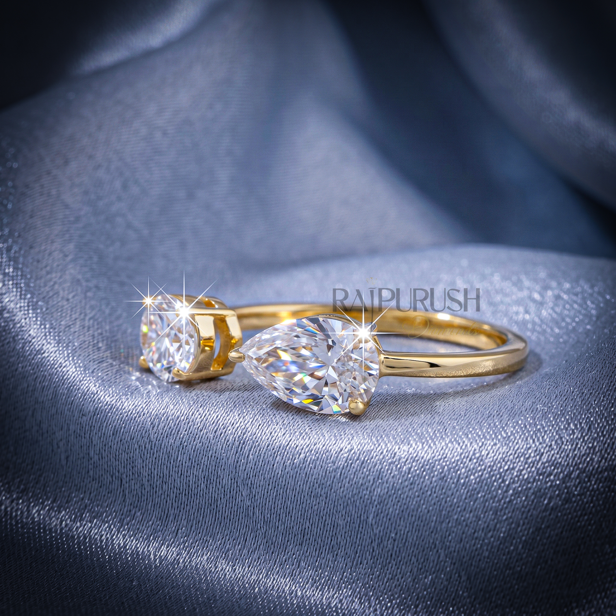 A modern "Toi et Moi" style engagement ring featuring pear and oval cut moissanite stones, finished in 14k yellow/rose gold plating.