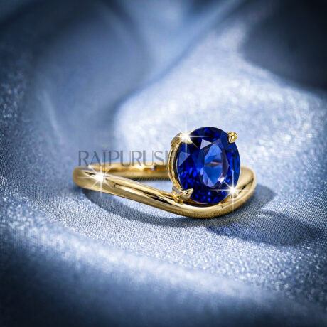 A stunning 1ct round brilliant cut blue sapphire solitaire engagement ring with a polished gold-plated band