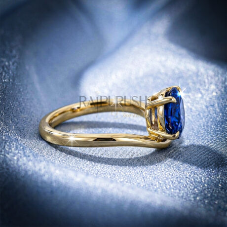 A stunning 1ct round brilliant cut blue sapphire solitaire engagement ring with a polished gold-plated band