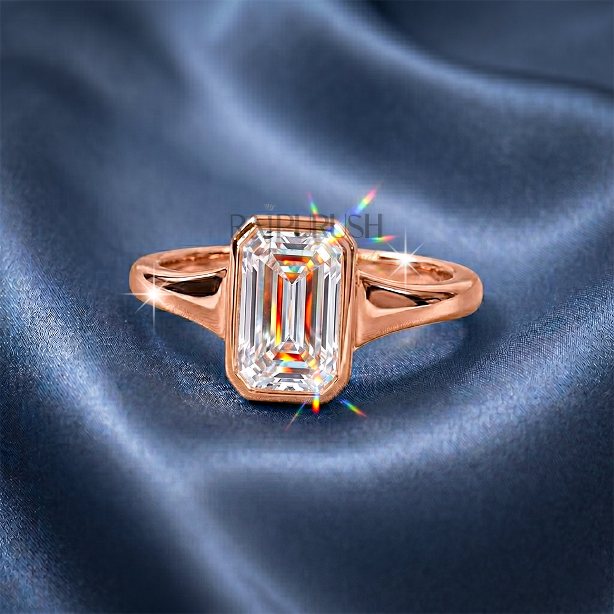 A stunning 1ct emerald cut moissanite engagement ring featuring a secure full bezel setting on a polished 14k gold band