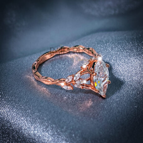 Modern 925 sterling silver engagement ring featuring a horizontally set marquise cut moissanite diamond solitaire on an ultra-dainty high-polish rose gold plating band