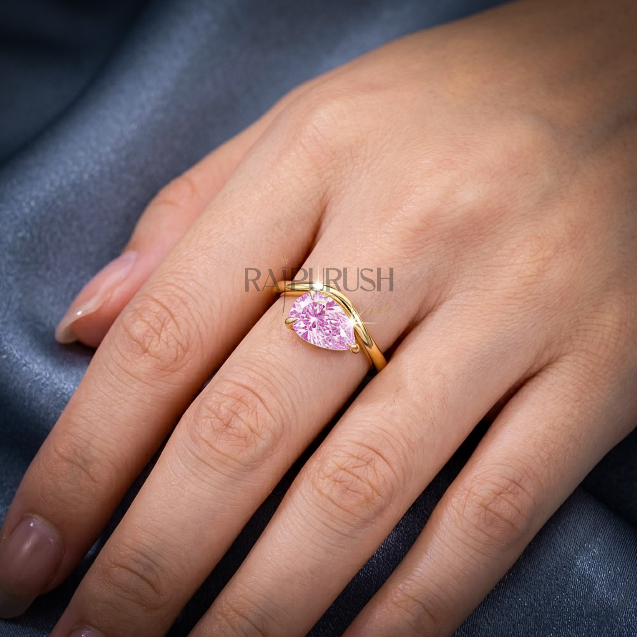 A stunning 1ct pear-cut moissanite solitaire engagement ring set in polished 14k gold