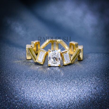 Close-up of a radiant cut and baguette moissanite engagement ring in 14k yellow gold plated sterling silver