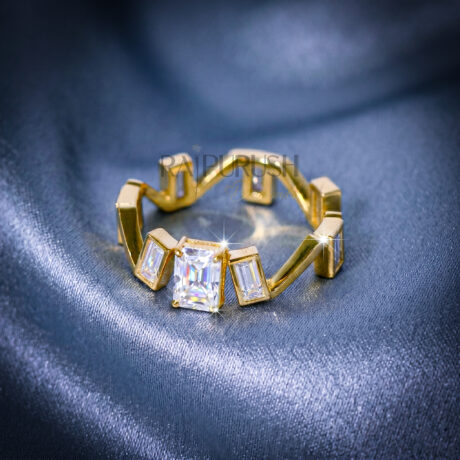 Close-up of a radiant cut and baguette moissanite engagement ring in 14k yellow gold plated sterling silver