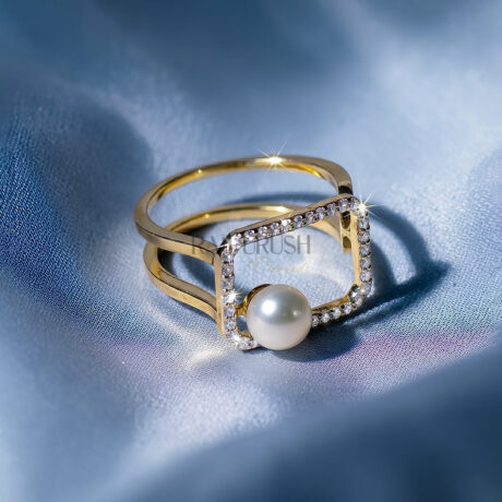 Modern geometric open frame statement ring in 14k gold plated silver featuring a floating white pearl and micro pavé moissanite border on a blue silk background.