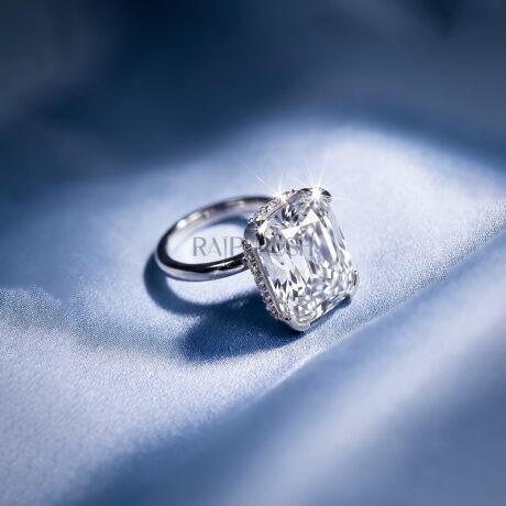 Elongated Cushion cut moissanite solitaire engagement ring in solid silver showcasing incredible crushed ice brilliance on blue silk.