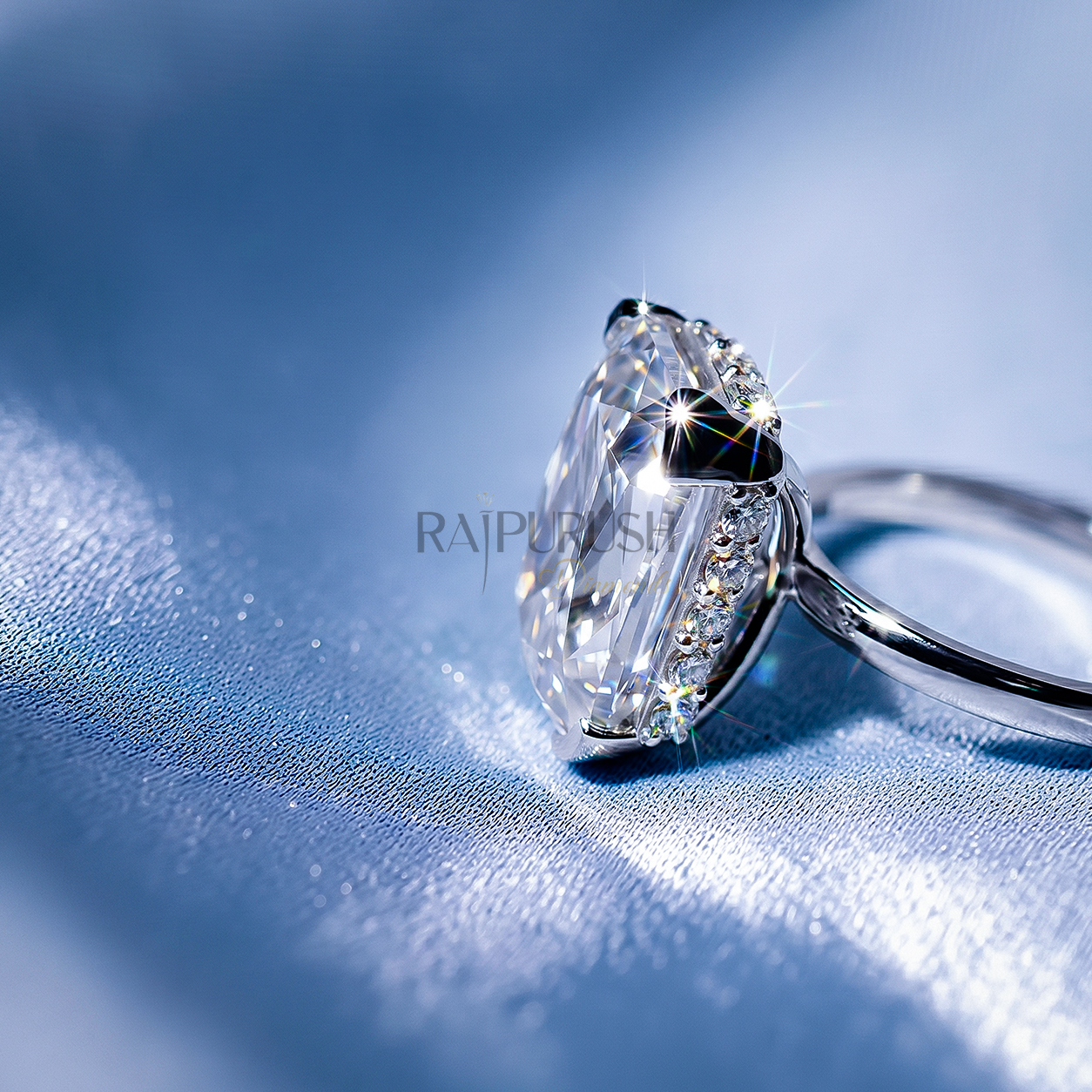 Elongated Cushion cut moissanite solitaire engagement ring in solid silver showcasing incredible crushed ice brilliance on blue silk.