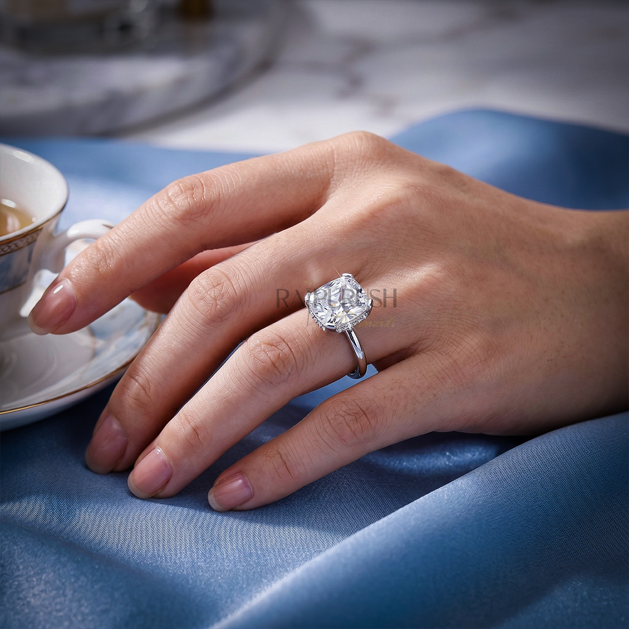 Elongated Cushion cut moissanite solitaire engagement ring in solid silver showcasing incredible crushed ice brilliance on blue silk.