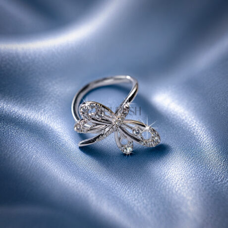 High-shine 925 sterling silver dragonfly ring featuring openwork filigree wings accent-set with brilliant round moissanite diamonds on a smooth comfort-fit band.
