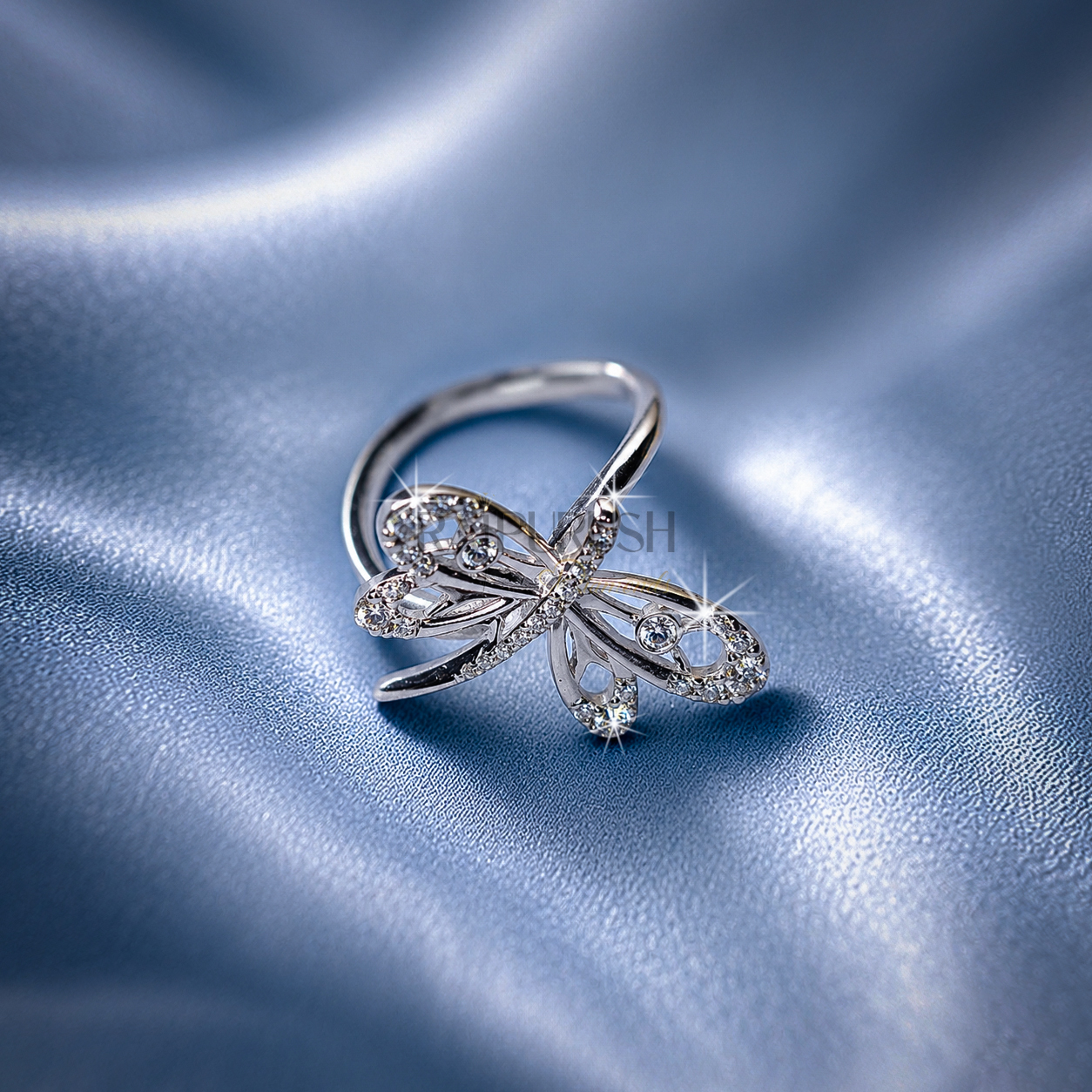 High-shine 925 sterling silver dragonfly ring featuring openwork filigree wings accent-set with brilliant round moissanite diamonds on a smooth comfort-fit band.