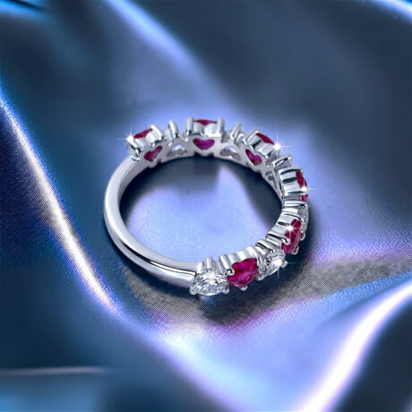 Romantic heart-shaped moissanite diamond eternity wedding band in S925 sterling silver, featuring a continuous row of shared-prong heart stones in a low-profile stackable layout.