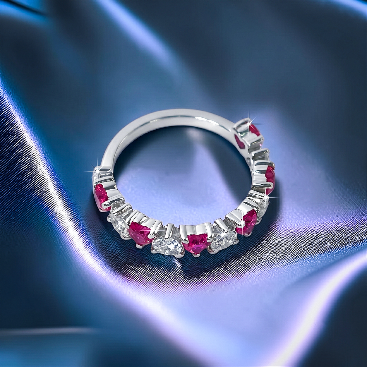 Romantic heart-shaped moissanite diamond eternity wedding band in S925 sterling silver, featuring a continuous row of shared-prong heart stones in a low-profile stackable layout.