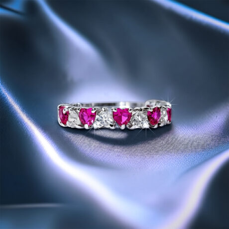 Romantic heart-shaped moissanite diamond eternity wedding band in S925 sterling silver, featuring a continuous row of shared-prong heart stones in a low-profile stackable layout.