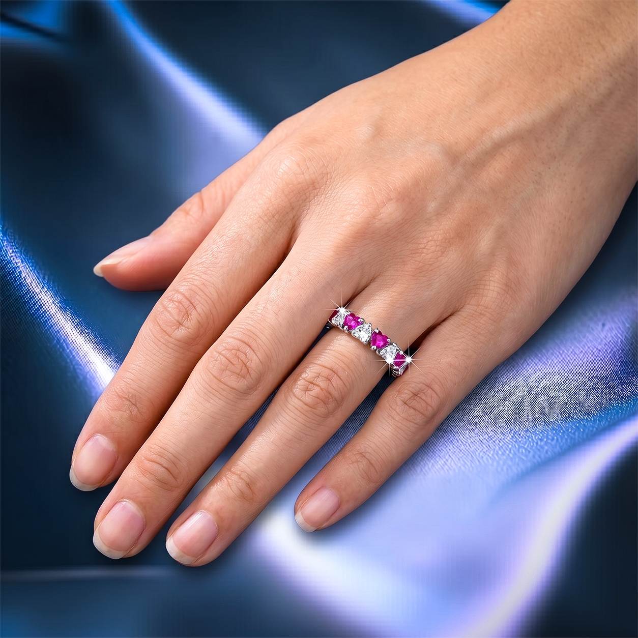 Romantic heart-shaped moissanite diamond eternity wedding band in S925 sterling silver, featuring a continuous row of shared-prong heart stones in a low-profile stackable layout.