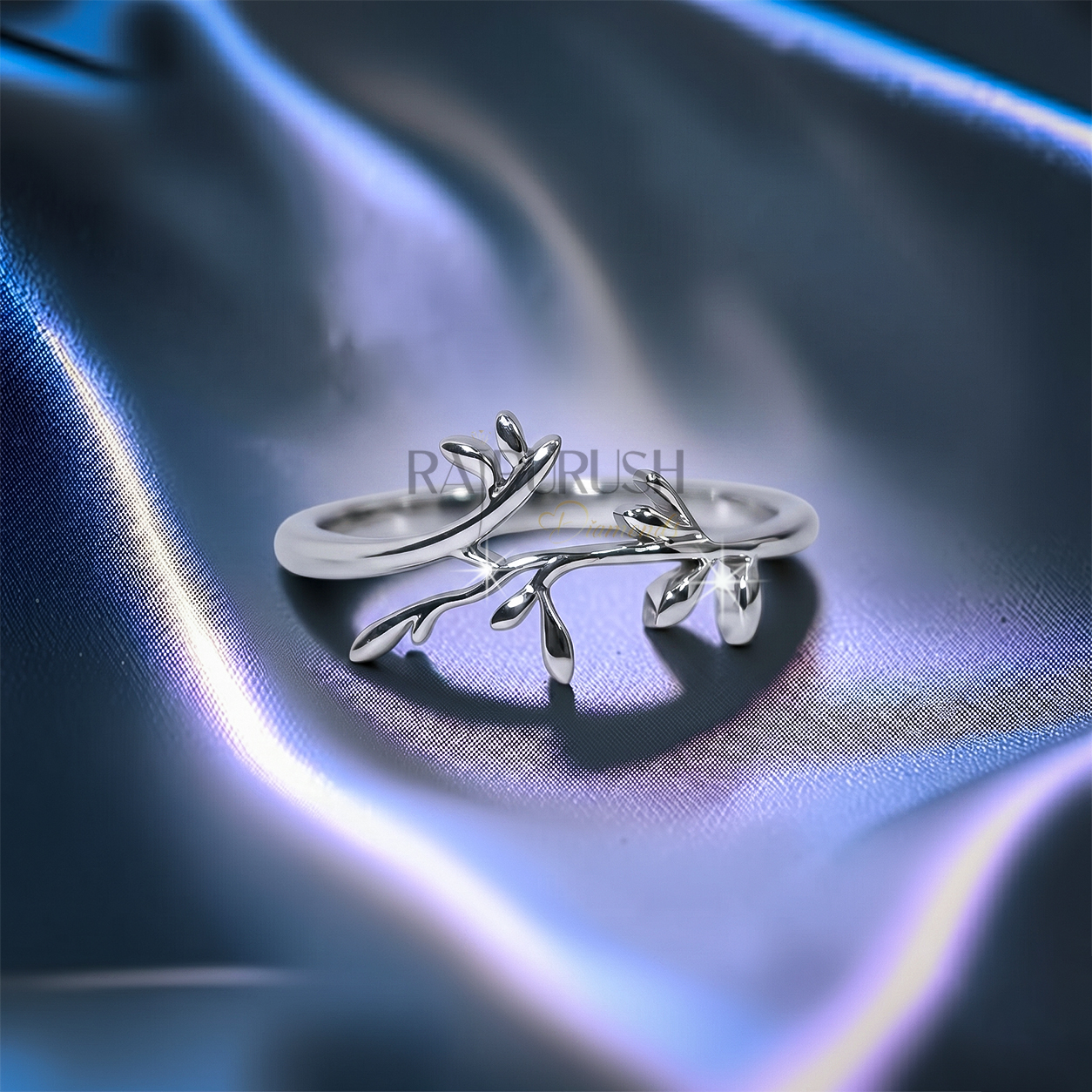 High-polish 925 sterling silver nature-inspired wedding band featuring a delicate bypassing leaf and vine branch motif in a stackable boho bridal style.