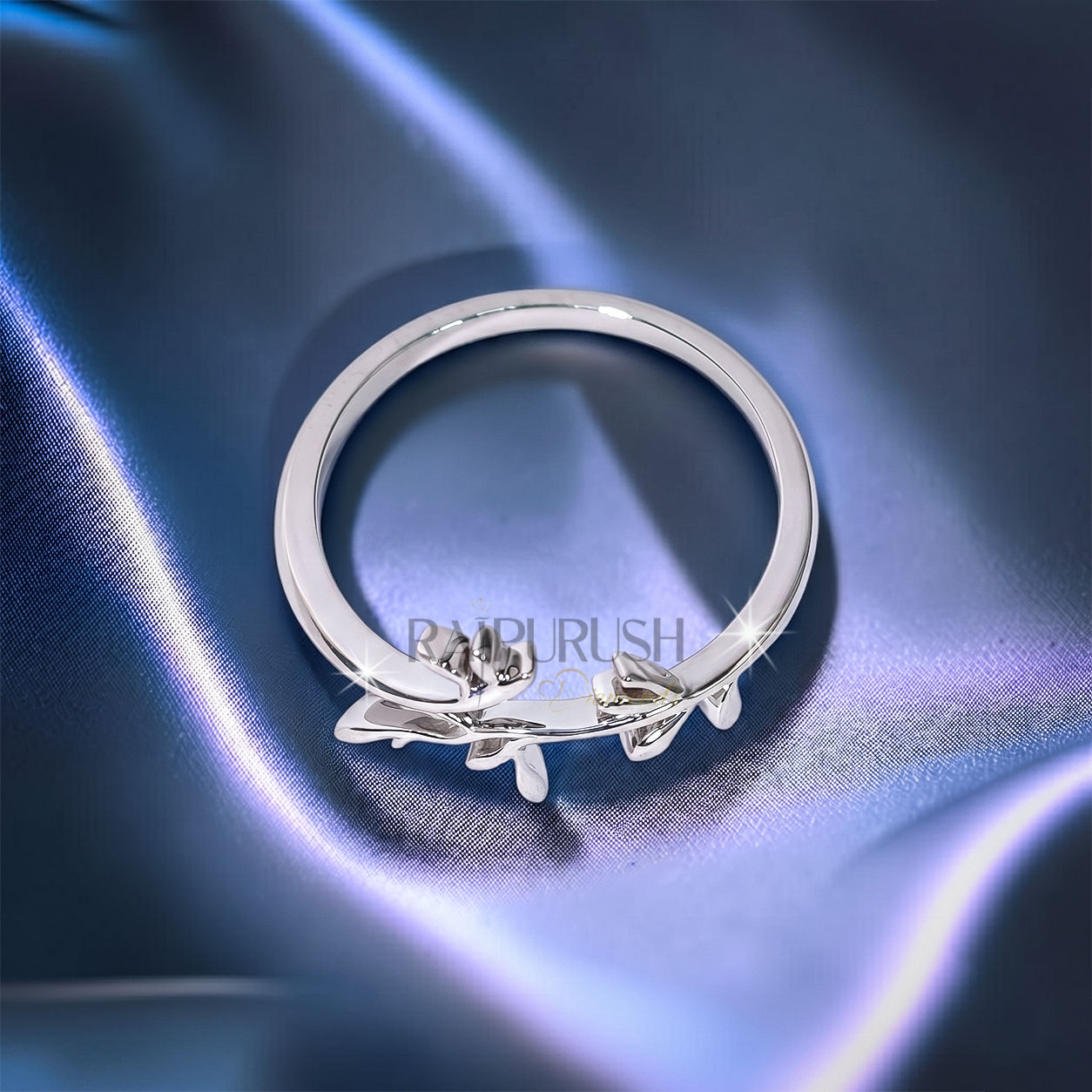 High-polish 925 sterling silver nature-inspired wedding band featuring a delicate bypassing leaf and vine branch motif in a stackable boho bridal style.