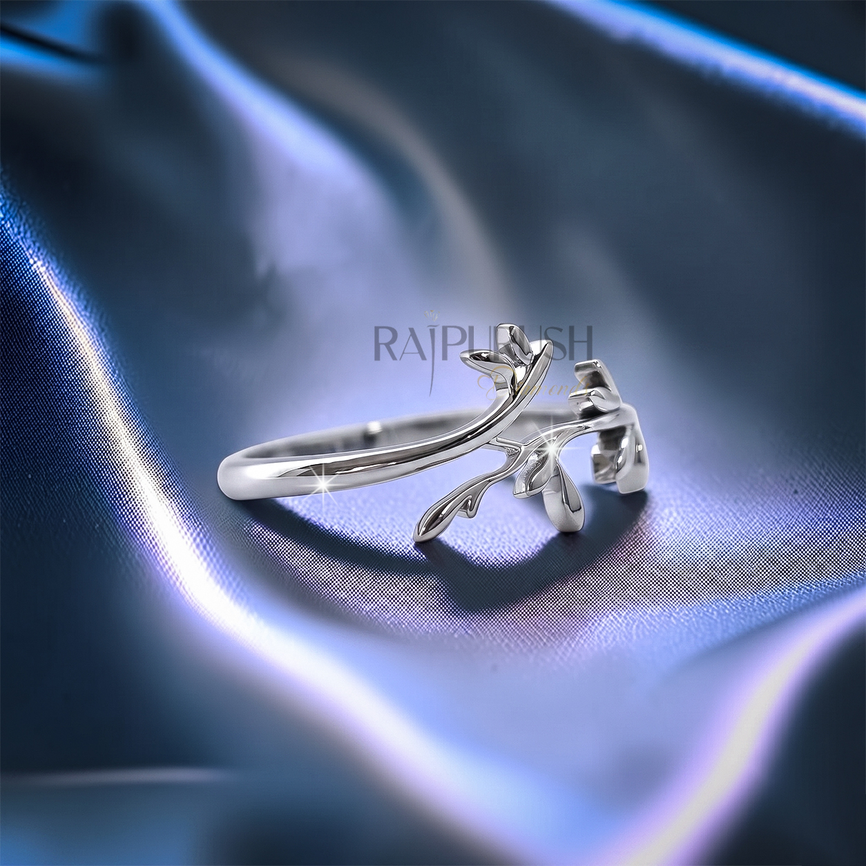 High-polish 925 sterling silver nature-inspired wedding band featuring a delicate bypassing leaf and vine branch motif in a stackable boho bridal style.