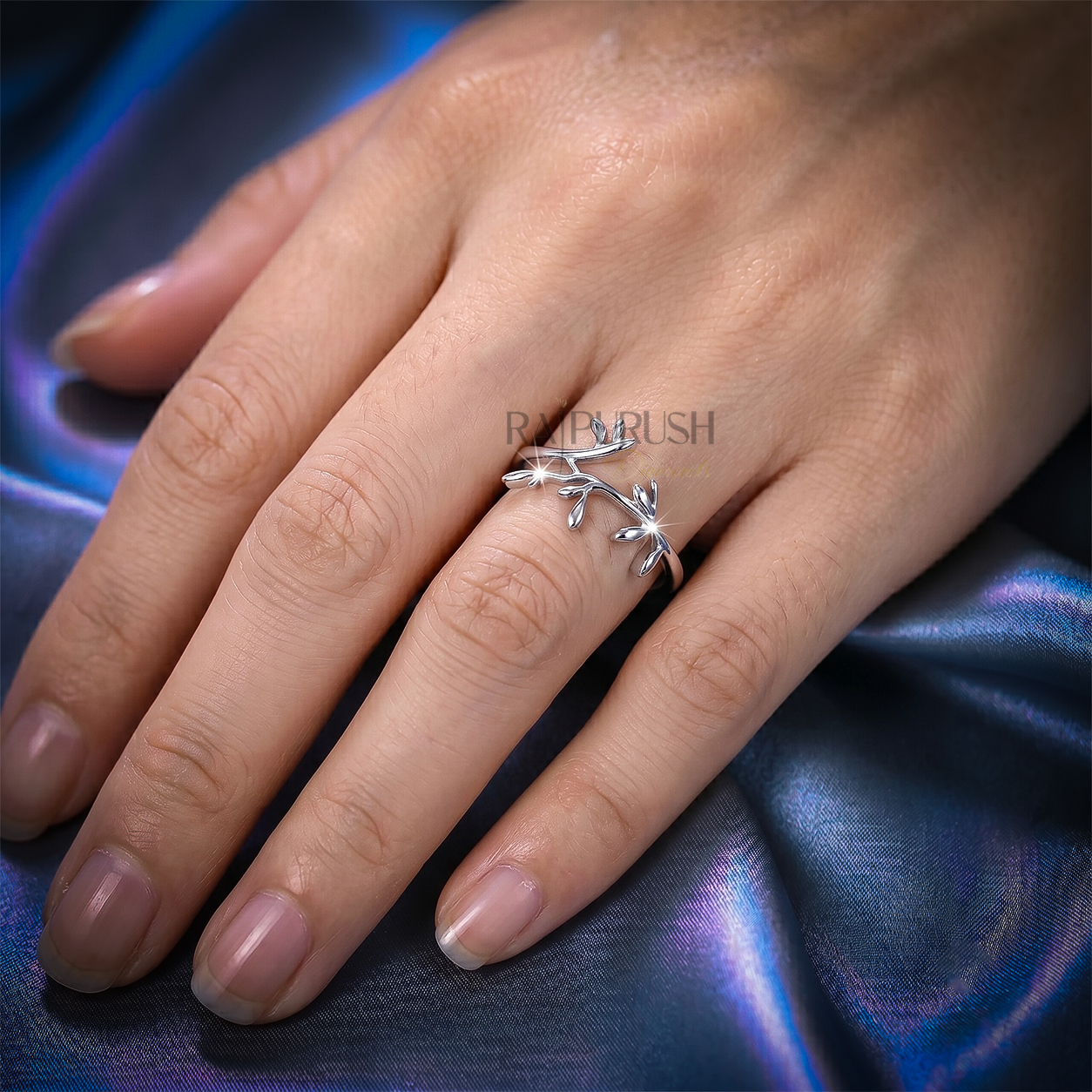High-polish 925 sterling silver nature-inspired wedding band featuring a delicate bypassing leaf and vine branch motif in a stackable boho bridal style.