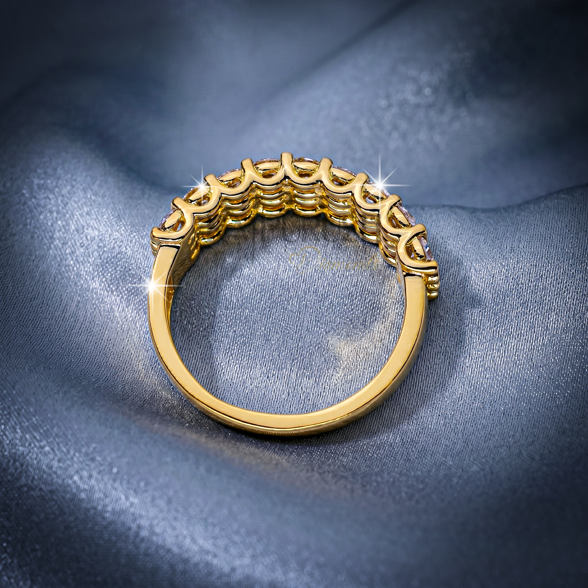A double row round moissanite wedding band, set in 14k yellow gold plated sterling silver.