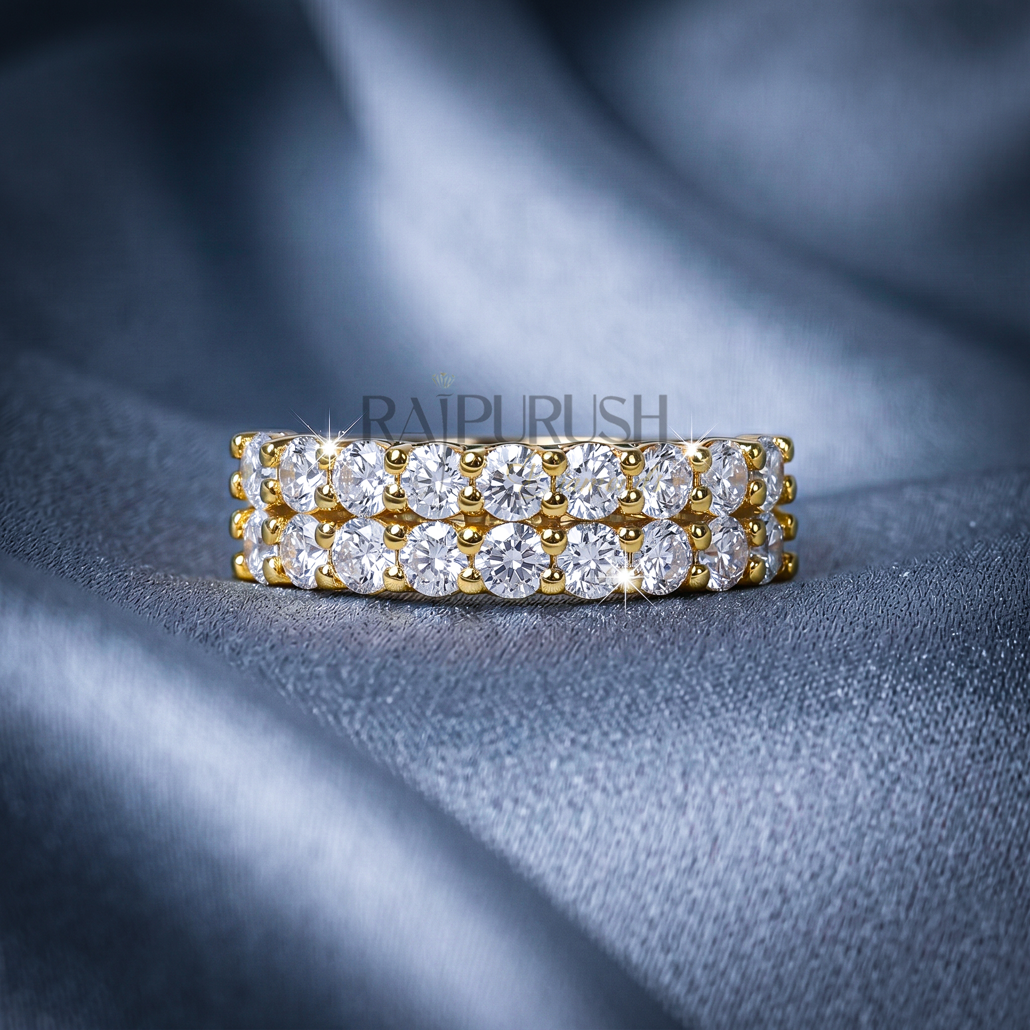 A double row round moissanite wedding band, set in 14k yellow gold plated sterling silver.
