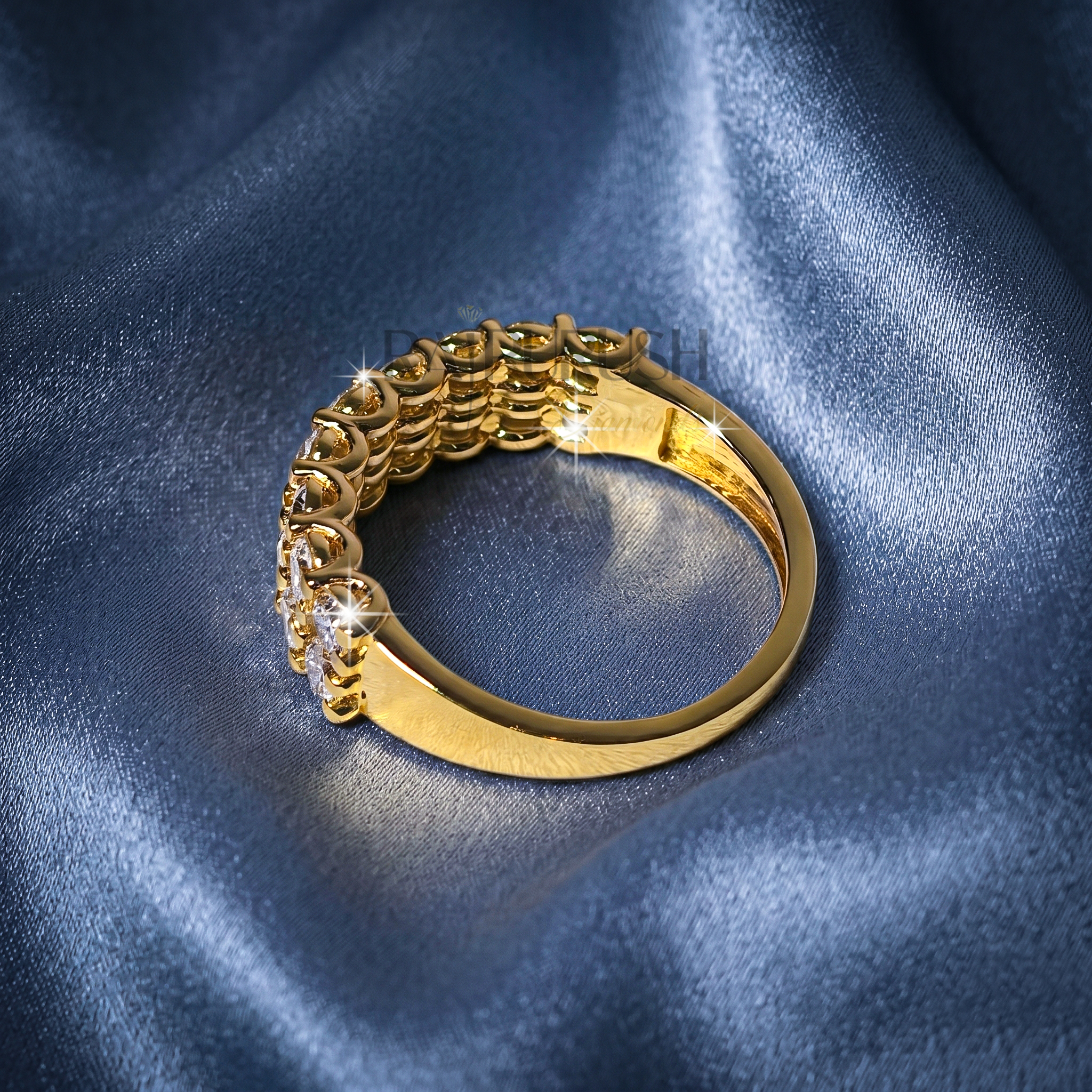 A double row round moissanite wedding band, set in 14k yellow gold plated sterling silver.