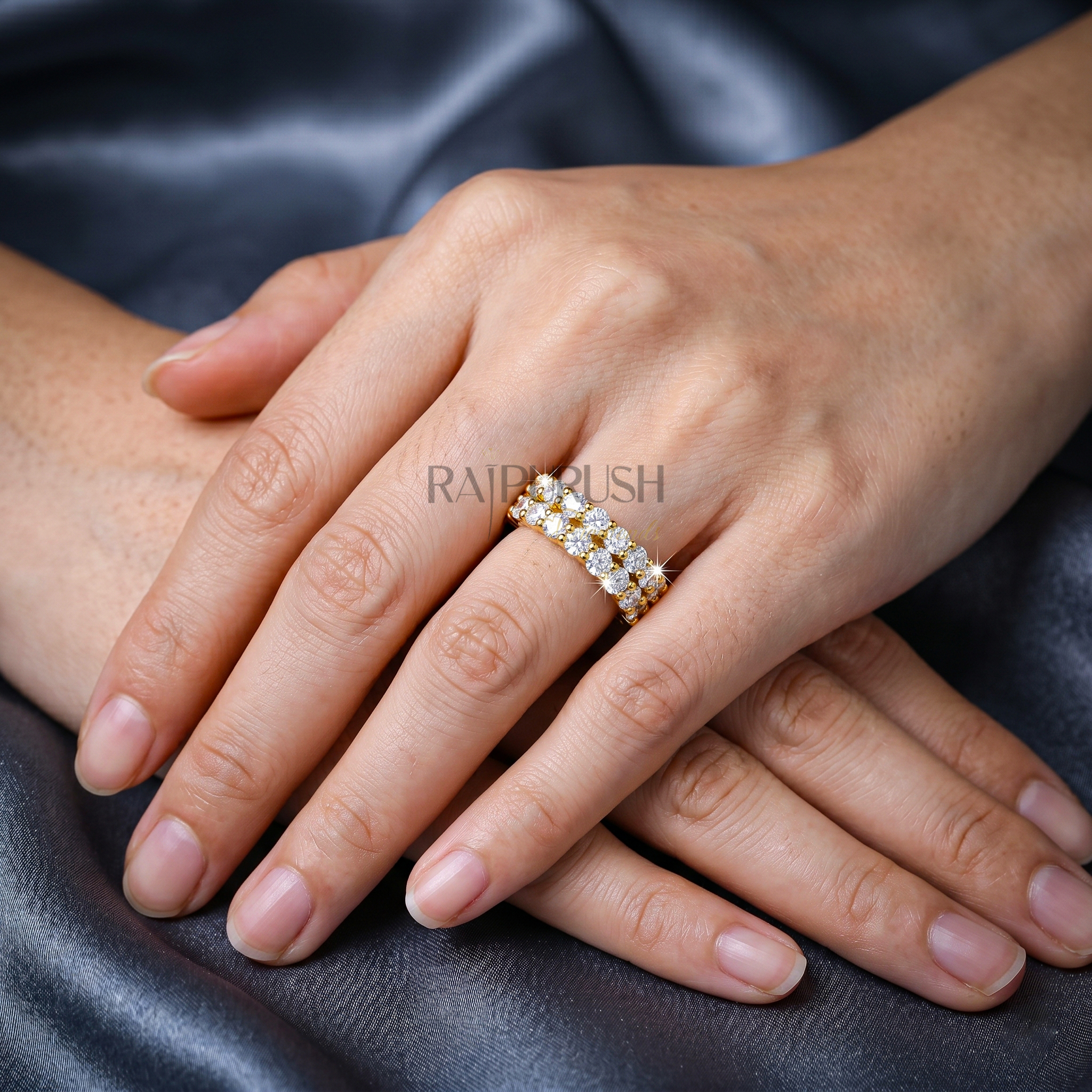 A double row round moissanite wedding band, set in 14k yellow gold plated sterling silver.